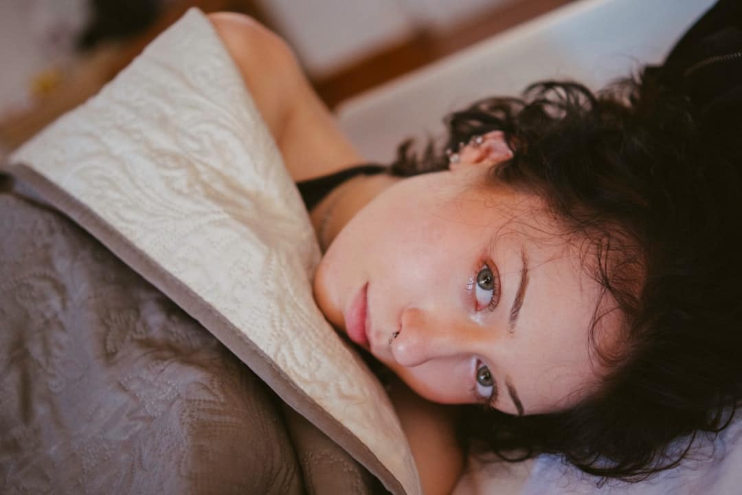 Woman resting in bed during menstrual discomfort